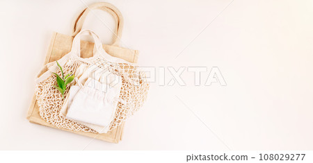 Eco Bags.A variety of eco bags on a yellow background . Sustainable lifestyle.Zero waste minimal composition with tring and canvas bags for storage.Zero waste, eco friendly shopping.Top view,flat lay. 108029277