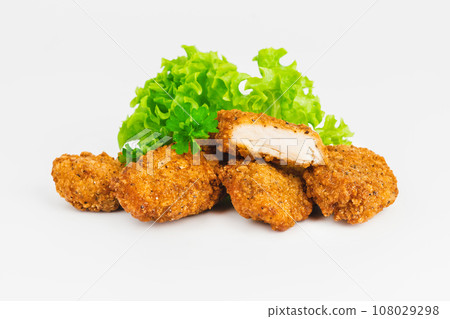 Breaded Chicken Inner Fillet on a White Background,Chicken Breaded Raw Meat.Chicken Breaded Fillet. Breaded chicken nuggets. Fast homemade food at home. Chicken breaded schnitzels. Fast cooking. 108029298