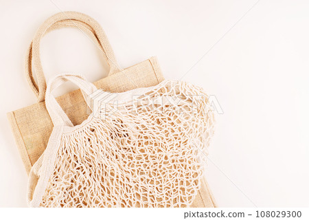Eco Bags.A variety of eco bags on a yellow background . Sustainable lifestyle.Zero waste minimal composition with tring and canvas bags for storage.Zero waste, eco friendly shopping.Top view,flat lay. 108029300