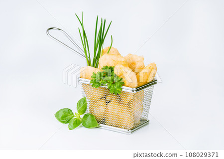 Breaded chicken nuggets. Breaded Chicken Inner Fillet with green lettuce leaves on a White Background,Chicken Breaded Raw Meat,Fillet.Fast homemade food at home.Chicken breaded schnitzels.Fast cooking 108029371