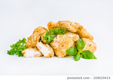 Chicken Breaded Fillet. Breaded chicken nuggets. Fast homemade food at home. Chicken breaded schnitzels. Breaded Chicken Inner Fillet on a White Background,Chicken Breaded Raw Meat. Fast cooking. 108029414
