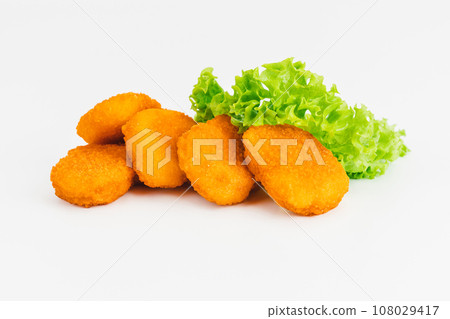 Breaded Chicken Inner Fillet with green lettuce leaves on a White Background,Chicken Breaded Raw Meat,Fillet.Breaded chicken nuggets. Fast homemade food at home.Chicken breaded schnitzels.Fast cooking Breaded Chicken Inner Fillet with green lettuce leaves on a White Background,Chicken Breaded Raw Meat,Fillet.Breaded chicken nuggets. Fast homemade food at home.Chicken breaded schnitzels.Fast cooking 108029417