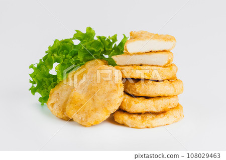 Breaded Chicken Inner Fillet on a White Background,Chicken Breaded Raw Meat.Chicken Breaded Fillet. Breaded chicken nuggets. Fast homemade food at home. Chicken breaded schnitzels. Fast cooking. 108029463