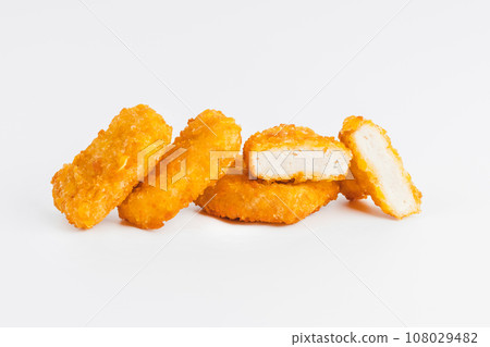 Chicken Breaded Fillet. Breaded chicken nuggets. Fast homemade food at home. Chicken breaded schnitzels. Breaded Chicken Inner Fillet on a White Background,Chicken Breaded Raw Meat. Fast cooking. 108029482