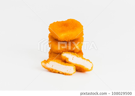 Breaded Chicken Inner Fillet on a White Background,Chicken Breaded Raw Meat.Chicken Breaded Fillet. Breaded chicken nuggets. Fast homemade food at home. Chicken breaded schnitzels. Fast cooking. 108029500