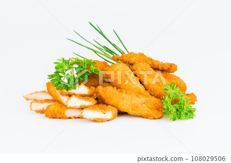 Chicken Breaded Fillet. Breaded chicken nuggets. Fast homemade food at home. Chicken breaded schnitzels. Breaded Chicken Inner Fillet on a White Background,Chicken Breaded Raw Meat. Fast cooking. 108029506