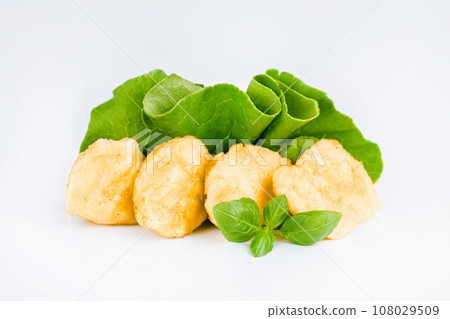 Breaded Chicken Inner Fillet with green lettuce leaves on a White Background,Chicken Breaded Raw Meat,Fillet.Breaded chicken nuggets. Fast homemade food at home.Chicken breaded schnitzels.Fast cooking 108029509