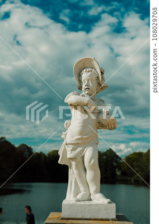 A beautiful white sculpture stands on the shore of the lake. A beautiful white sculpture stands on the shore of the lake. 108029708