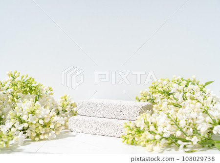 Eco friendly cosmetics skin care product presentation scene made with pumice stones and blossom lilac branch on white background. Eco friendly cosmetics skin care product presentation scene made with pumice stones and blossom lilac branch on white background. 108029738