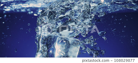 Water splashing and ice cube. Ice splashing into a glass of water. Underwater pouring ice cubes falling into clear watering background. Refreshing chill drinking. Ices in a glass with blue background 108029877