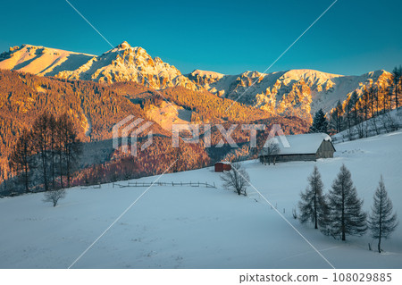 Winter scenery with snow covered high mountains at sunset Winter scenery with snow covered high mountains at sunset 108029885