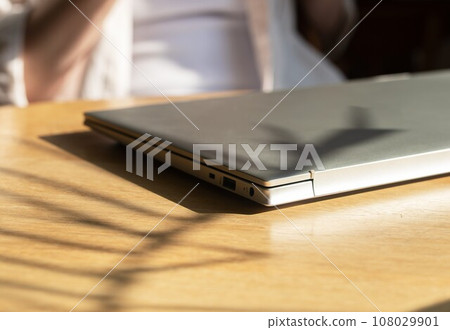 Closed laptop on wooden desk. Finished end done work Closed laptop on wooden desk. Finished end done work 108029901