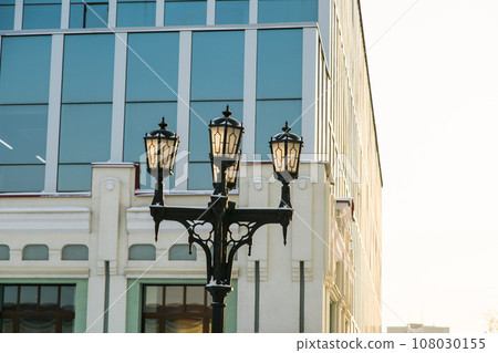 Street light in city winter season on background a hotel building. Copy space and empty place for text and advertising Street light in city winter season on background a hotel building. Copy space and empty place for text and advertising 108030155