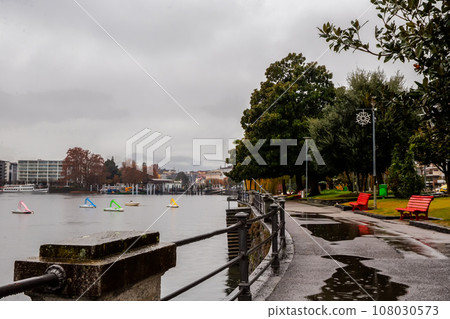 Sailboats in parking lots next to shore , panorama of embankment of Locarno Sailboats in parking lots next to shore , panorama of embankment of Locarno 108030573