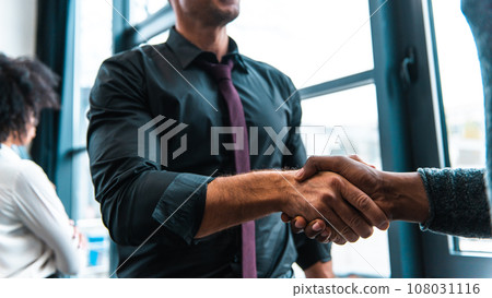 Handshaking of business people in office as concept of teamwork and partnership Handshaking of business people in office as concept of teamwork and partnership 108031116