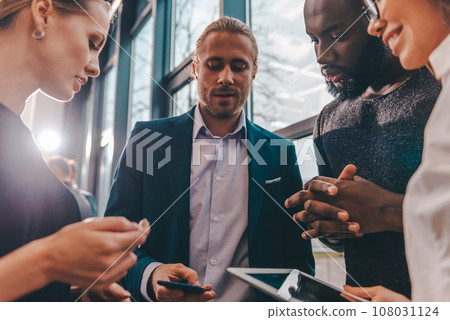 Business people watche something in internet streming with tablet and smartphone Business people watche something in internet streming with tablet and smartphone 108031124