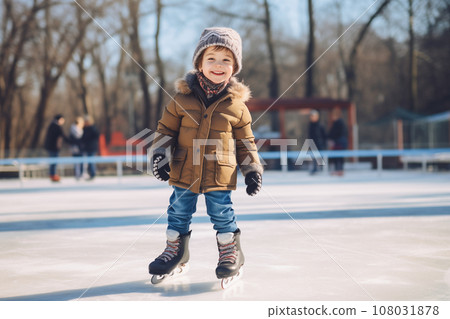 Happy boy having fun and skating on an outdoor ice rink Happy boy having fun and skating on an outdoor ice rink 108031878