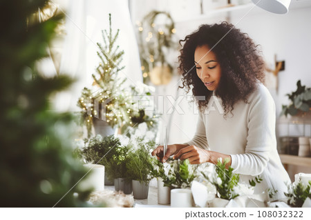 African American woman florist creating Christmas decor in flower shop. Small business 108032322