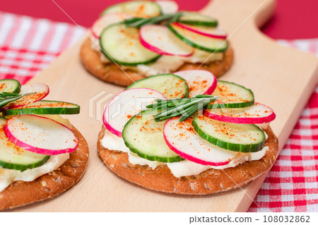 Cracker Sandwich with Cream Cheese, Fresh Cucumber and Radish Cracker Sandwich with Cream Cheese, Fresh Cucumber and Radish 108032862