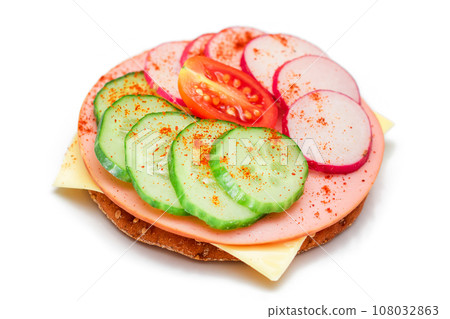 Cracker Sandwich with Fresh Cucumber, Cheese, Sausage, Radish and Tomato - Isolated Cracker Sandwich with Fresh Cucumber, Cheese, Sausage, Radish and Tomato - Isolated 108032863