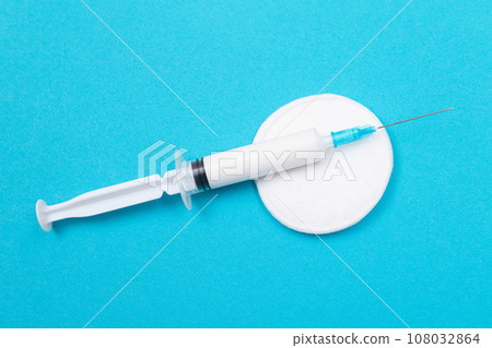 Vaccination or Revaccination Concept - A Medical Syringe on Blue Table Vaccination or Revaccination Concept - A Medical Syringe on Blue Table 108032864