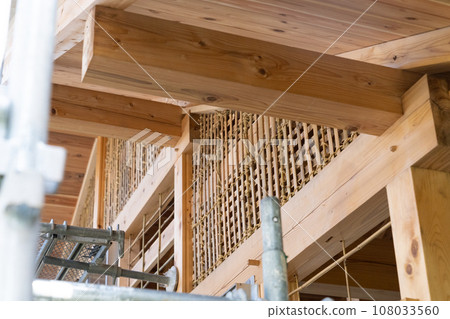 Earth wall base for plastering work at a wooden house site 108033560