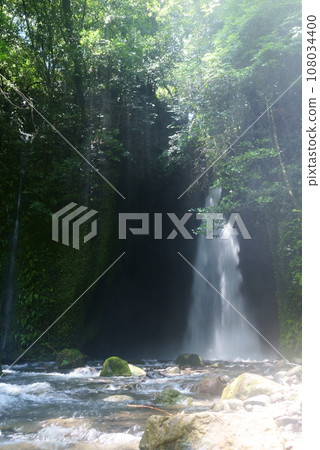 Mysterious Nagano Falls with sunlight filtering through the trees Mysterious Nagano Falls with sunlight filtering through the trees 108034400