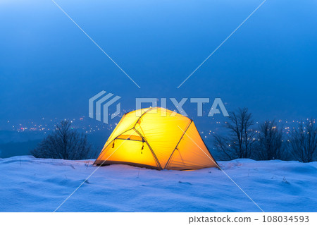 A yellow tent illuminated from within A yellow tent illuminated from within 108034593