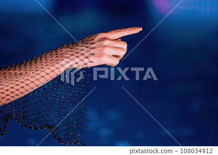 Glamorous woman hand pointing right side, pool water background. Shining outfit Glamorous woman hand pointing right side, pool water background. Shining outfit 108034912