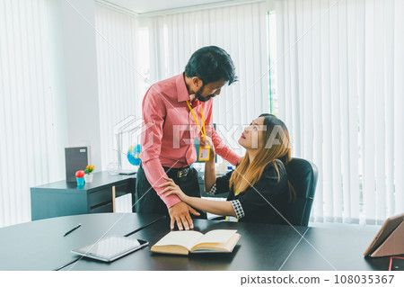 Boss or supervisor touching female employee's shoulder Causing young employees to resist because they are uncomfortable and afraid of being sexually abused. Concept of sexual harassment in the 108035367