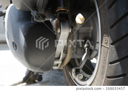 Oil leak from rear suspension of motorcycle Oil leak from rear suspension of motorcycle 108035457