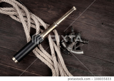 Retro vintage spyglass telescope with sextant 108035833