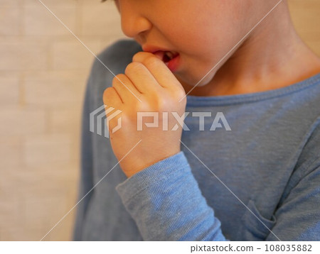 A boy who can't stop biting his nails 108035882