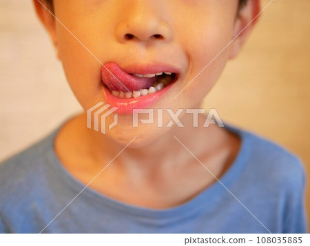 A boy licking his tongue A boy licking his tongue 108035885