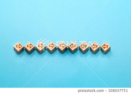 A blue background where wood cubes with different numbers of arrows on the left and right collide in the center A blue background where wood cubes with different numbers of arrows on the left and right collide in the center 108037751