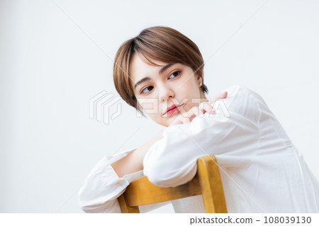 Woman sitting on chair 108039130