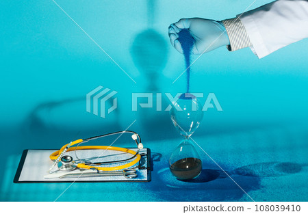 Medical technology, we can now extend more time to people's life, The goal of medicine is to prolong more time to people's lives and improve their quality of life. Doctor pouring sand to hourglass Medical technology, we can now extend more time to people's life, The goal of medicine is to prolong more time to people's lives and improve their quality of life. Doctor pouring sand to hourglass 108039410
