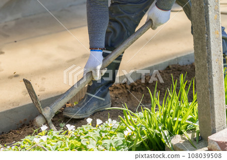 Workers digging trenches with pickaxes Workers digging trenches with pickaxes 108039508