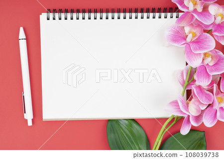Empty notebook and pen with pink orchid. 108039738