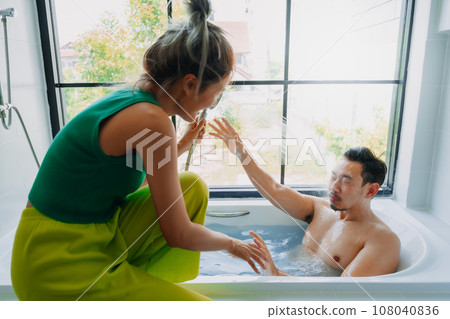 Funny playful asian couple lover play in the bathtub in the bathroom. Funny playful asian couple lover play in the bathtub in the bathroom. 108040836