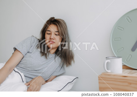 Displease and unhappy woman has to wake up in the morning. 108040837