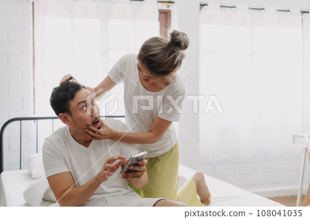 Woman angry on man who keep chatting on the phone. Funny couple fight. Woman angry on man who keep chatting on the phone. Funny couple fight. 108041035