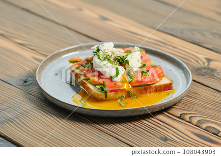 Benedict sandwich with salmon and poached egg Benedict sandwich with salmon and poached egg 108043903
