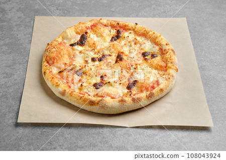 Pizza with assortment of cheese on parchment paper Pizza with assortment of cheese on parchment paper 108043924