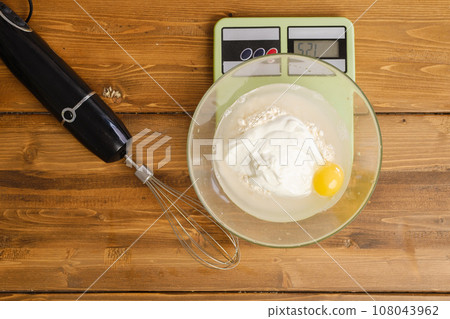 Weighing pancake ingredients in a bowl 108043962
