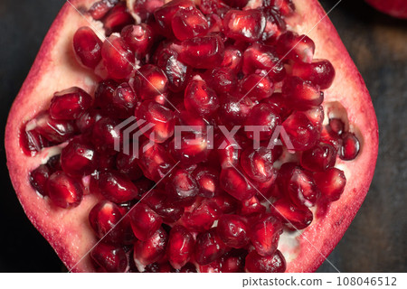 Fresh pomegranate on the kitchen table 108046512