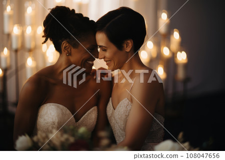 A tender moment between newlyweds during their same-sex wedding ceremony, emphasizing love, commitment, and inclusivity. Generative AI 108047656