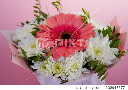 A beautiful bright bouquet of blooming fresh gerberas for a gift collected by an experienced florist 108048277