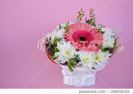 A beautiful bright bouquet of blooming fresh gerberas for a gift collected by an experienced florist 108048282