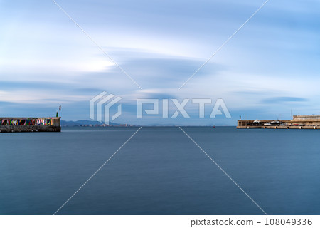 Long Exposure of Harbor Mouth Towards Open Sea at Sunset 108049336